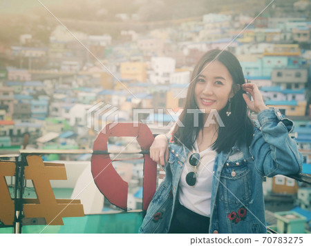 Young happy woman tourist in Gamcheon Culture Village, Busan, South Korea. Young happy woman tourist in Gamcheon Culture Village, Busan, South Korea. 70783275