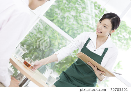 Cafe clerk carrying tea 70785301