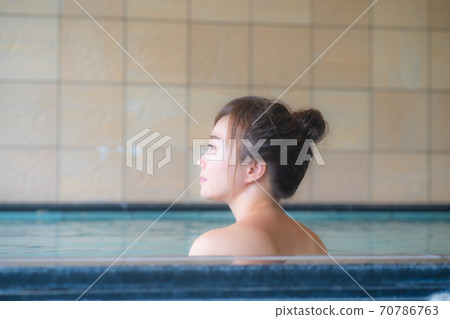 A woman entering a hot spring A woman entering a hot spring 70786763