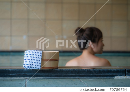 A woman entering a hot spring A woman entering a hot spring 70786764