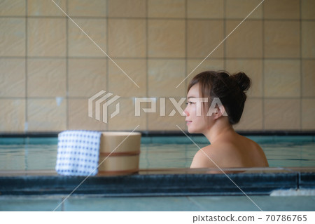 A woman entering a hot spring A woman entering a hot spring 70786765