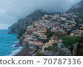 A high angle view of Positano with colorful buildings along the hillside. The morning atmosphere has fog over the city. 70787336