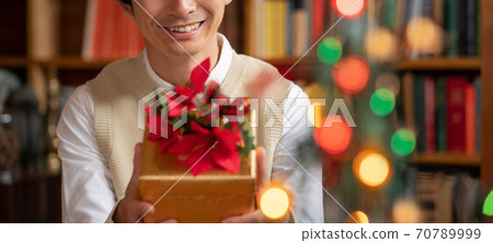 Banner size of a young man trying to give her a Christmas present Banner size of a young man trying to give her a Christmas present 70789999