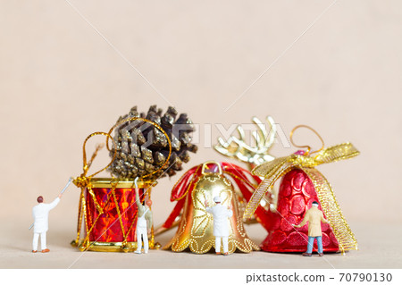 Miniature people,  Worker team painting a Christmas decoration 70790130