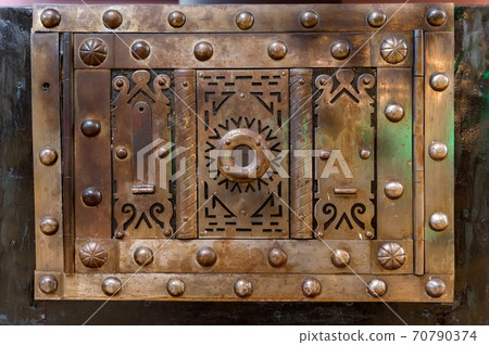 Close up of brass metal plate on chest cover 70790374