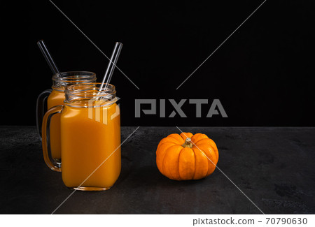 Two jars with mocktails and pumpkin on black Two jars with mocktails and pumpkin on black 70790630