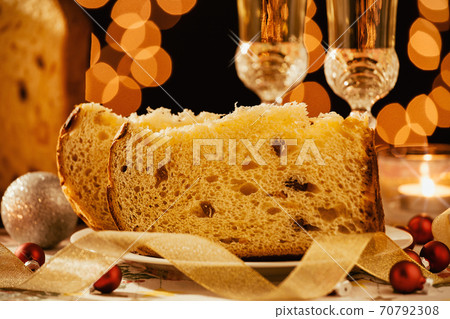Closeup of sliced italian panettone and sparkling wine Closeup of sliced italian panettone and sparkling wine 70792308
