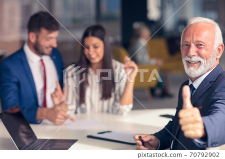 Positive aged couple consulting with insurance agent 70792902