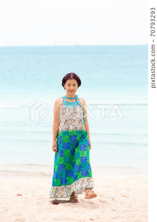 Asian middle aged woman relaxing at chaweng beach in koh samui ,Thailand. Asian middle aged woman relaxing at chaweng beach in koh samui ,Thailand. 70793293