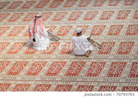 Two religious muslim man praying together inside the mosque 70793765