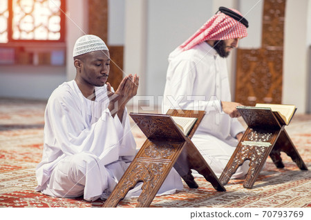 Religious black muslim man praying inside the mosque 70793769