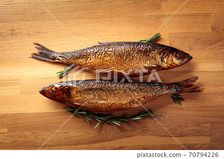 Smocked herring on a wooden table. Smocked herring on a wooden table. 70794226
