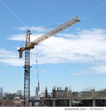 Industrial landscape with cranes on the blue sky Industrial landscape with cranes on the blue sky 70794252