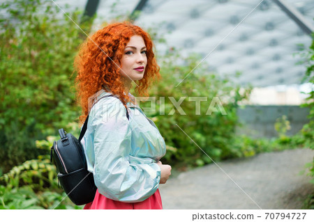 Girl Walking in Greenhouse 70794727