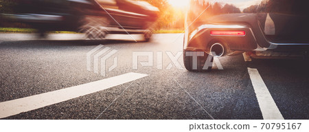 Car on asphalt road on summer day at park Car on asphalt road on summer day at park 70795167