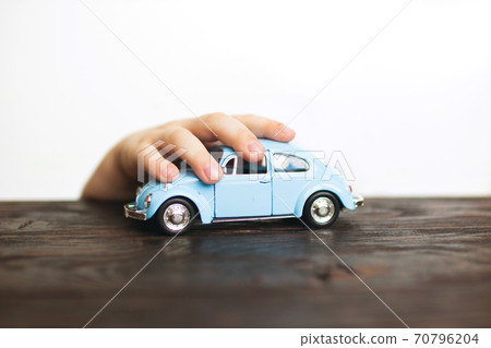 child playing with the car close on a white background 70796204