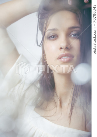young pretty brunette woman smiling happy on white background smooth blurred, lifestyle people concept 70796345