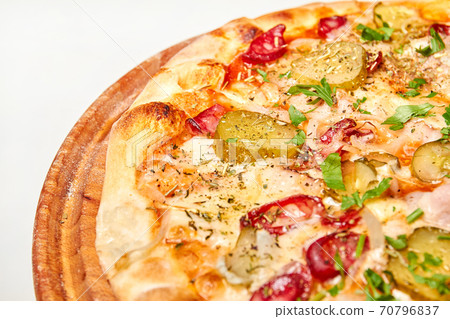 Fresh pizza pickles, bacon, sausages and cheese on a wooden board. Close-up, selective focus 70796837