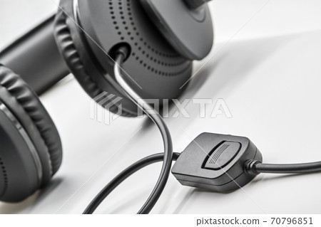 Remote Control from black headphones on white background. Closeup, selective focus Remote Control from black headphones on white background. Closeup, selective focus 70796851