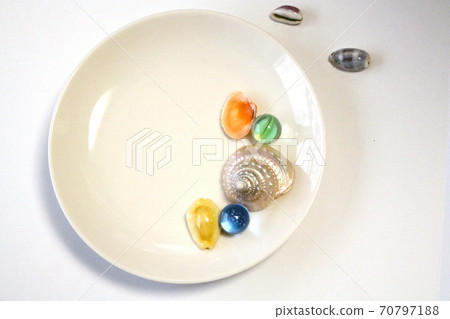 White plate, colorful seashells and marbles 70797188