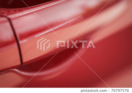 Closeup of red car with paint damage, long scratch 70797578