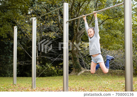 Girl playing on the horizontal bar 70800136
