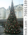 A large Christmas tree out in the square against the sky decorated with bright ornaments 70801189