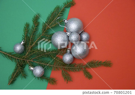 Christmas photos with silver tree balls and conifer branches on a red-green background Christmas photos with silver tree balls and conifer branches on a red-green background 70801201
