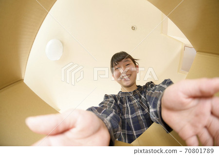 A girl who opens a product bought by mail order (view from the inside) A girl who opens a product bought by mail order (view from the inside) 70801789