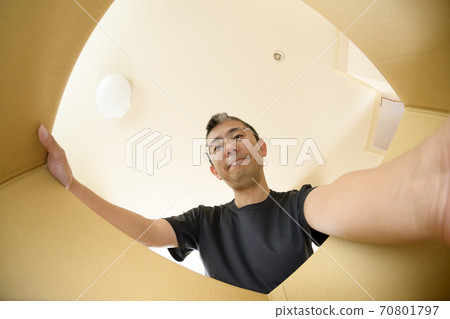 A man who opens a product bought by mail order (view from the inside) A man who opens a product bought by mail order (view from the inside) 70801797
