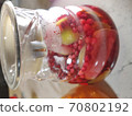cranberry compote in a glass jug close-up 70802192