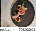 Sliced pear and a freshly prepared fillet of a duck 70802201
