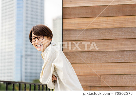 Woman relaxing on the balcony 70802573