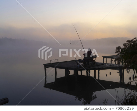 fisherman on Jenoi pond near Diosjeno, Northern Hungary fisherman on Jenoi pond near Diosjeno, Northern Hungary 70803259