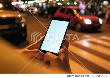 Mobile phone with blank screen in female hands Mobile phone with blank screen in female hands 70803537