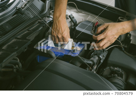 Engine engineer is replacing  car battery because car battery is depleted. 70804579