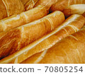French crispy loaves of baguette pastry background. Long loaf in rows at the bakery shop. 70805254