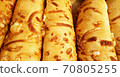 Loaf of cheese baguette pastry background. Long  french loaf in vertical rows at the bakery shop. 70805255