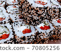 Sushi rolls maki in rows with salmon, cheese sauce and  cucumber closeup background.  70805256