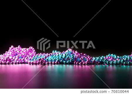 green and violet beads on a dark background 70810044