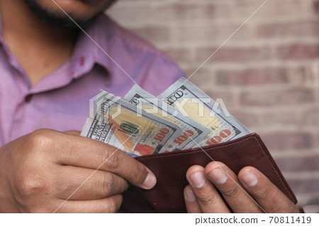 Close up of man hand taking cash out from wallet  70811419