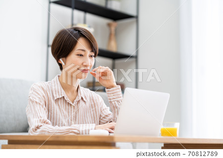 A woman doing telework in the living room. A woman doing telework in the living room. 70812789