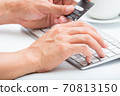 Person entering number of credit card with white 70813150