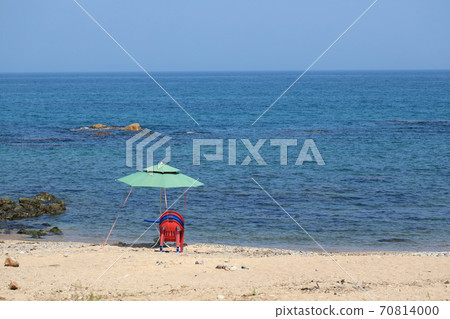 The beautiful scenery of the beach with a parasol view The beautiful scenery of the beach with a parasol view 70814000