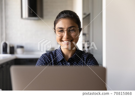 Smiling Indian woman in glasses work on laptop Smiling Indian woman in glasses work on laptop 70815868