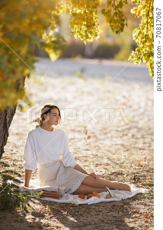 Woman in Autumn Park 70817067