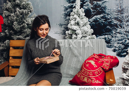 Beautiful brunette woman in sweater with Christmas Beautiful brunette woman in sweater with Christmas 70819039