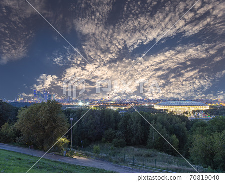 view of central Moscow from Sparrow Hills or Vorobyovy Gory observation (viewing) platform at sunset-- is on a steep bank 85 m above the Moskva river, or 200 m above sea level. Russia view of central Moscow from Sparrow Hills or Vorobyovy Gory observation (viewing) platform at sunset-- is on a steep bank 85 m above the Moskva river, or 200 m above sea level. Russia 70819040