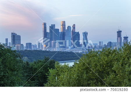 View of the city and skyscrapers Moscow city from Sparrow Hills or Vorobyovy Gory observation platform (against the backdrop of a beautiful sunset). Moscow, Russia View of the city and skyscrapers Moscow city from Sparrow Hills or Vorobyovy Gory observation platform (against the backdrop of a beautiful sunset). Moscow, Russia 70819280