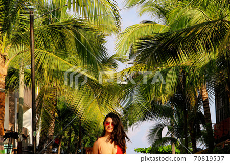 Woman at colorful street with palm trees in Sayulita, Nayarit, Mexico	 70819537